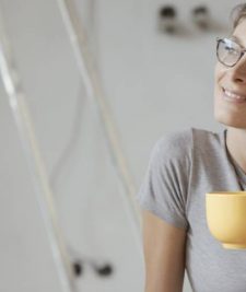 Lady relaxing after installing wireless interconnected photoelectric smoke alarms