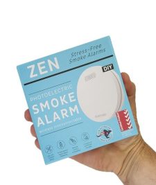 ZEN interconnected smoke alarm 1-pack box being held by hand - close up